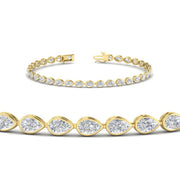 3.30-ct-pear-shape-east-west-bezel-diamond-tennis-bracelet-in-yellow-gold-FDBRCPE10581ANGLE2-3.30CT-NL-YG.jpg?v=1776840892